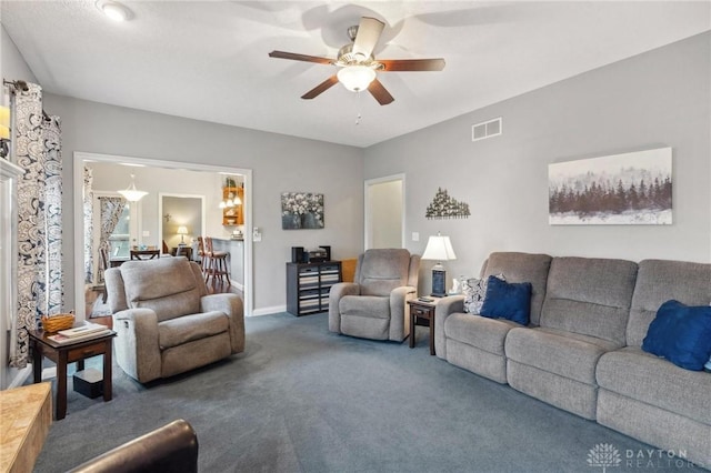 living room with dark colored carpet and ceiling fan