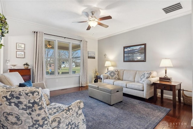 living room with crown molding, ceiling fan, and dark hardwood / wood-style flooring