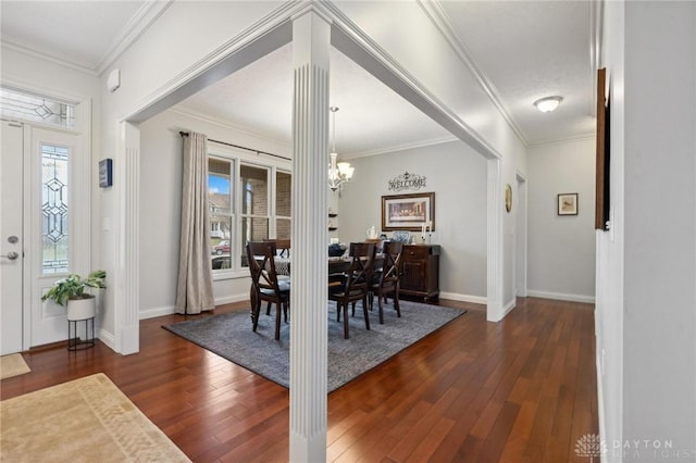 dining room featuring crown molding, dark hardwood / wood-style flooring, and an inviting chandelier