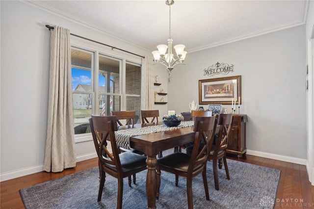 dining area featuring dark hardwood / wood-style flooring, crown molding, and an inviting chandelier