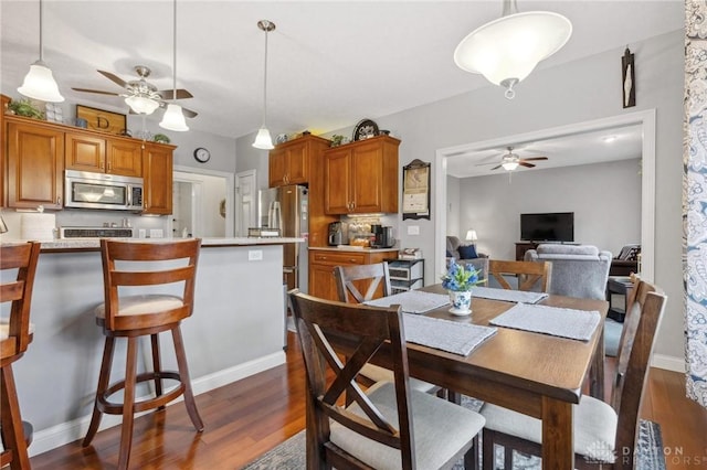 dining space featuring dark hardwood / wood-style floors and ceiling fan