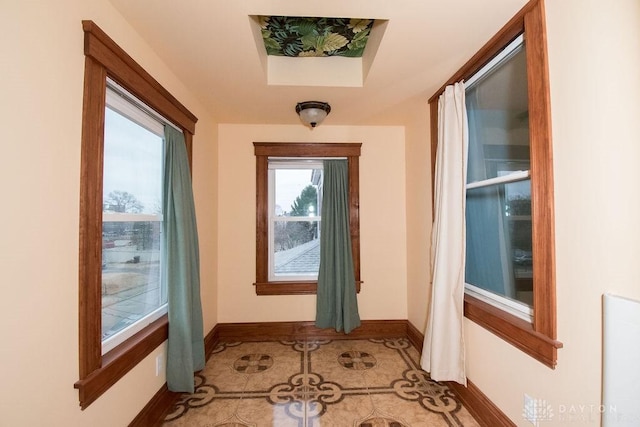 doorway to outside with tile patterned flooring