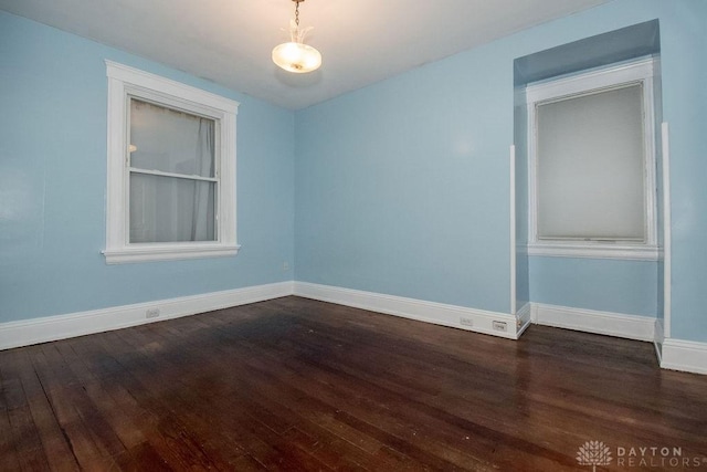 spare room with dark hardwood / wood-style flooring