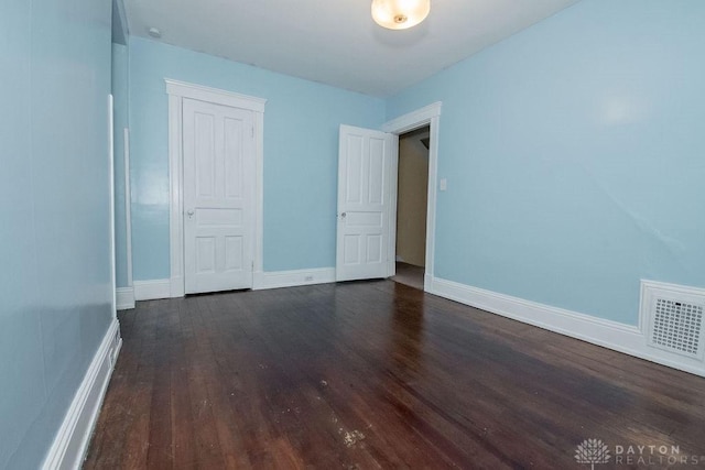 empty room featuring dark hardwood / wood-style flooring