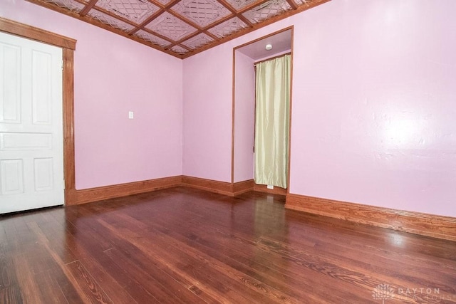 spare room featuring dark hardwood / wood-style flooring