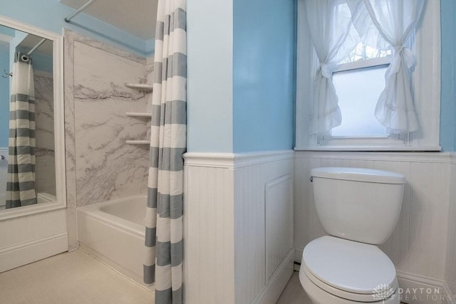 bathroom with toilet and shower / bath combo with shower curtain