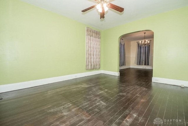 empty room featuring dark hardwood / wood-style floors and ceiling fan with notable chandelier