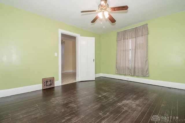 spare room featuring ceiling fan and dark hardwood / wood-style flooring