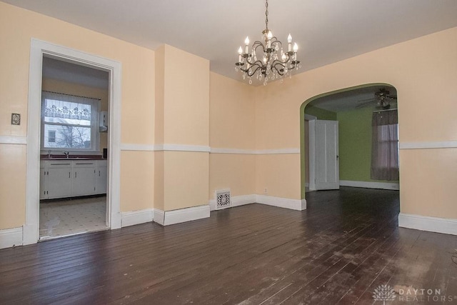 empty room with sink, an inviting chandelier, and dark hardwood / wood-style flooring