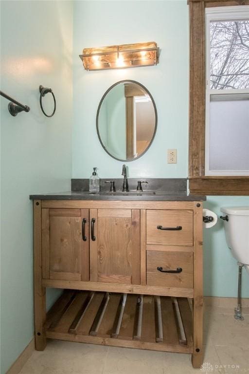 bathroom featuring tile patterned floors, vanity, and toilet