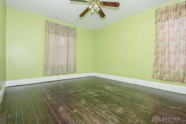 empty room with dark wood-type flooring and ceiling fan