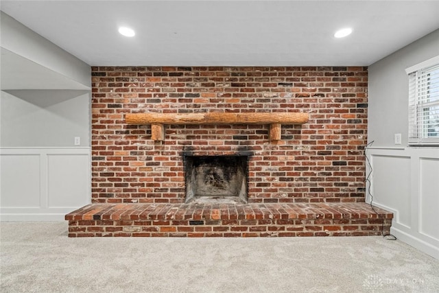 room details with carpet flooring and a brick fireplace