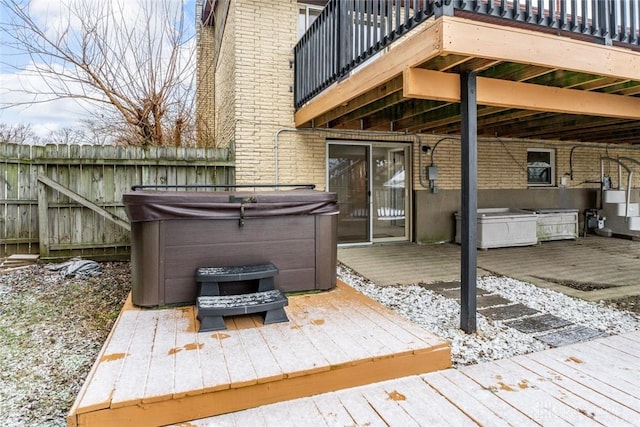 wooden terrace with a hot tub