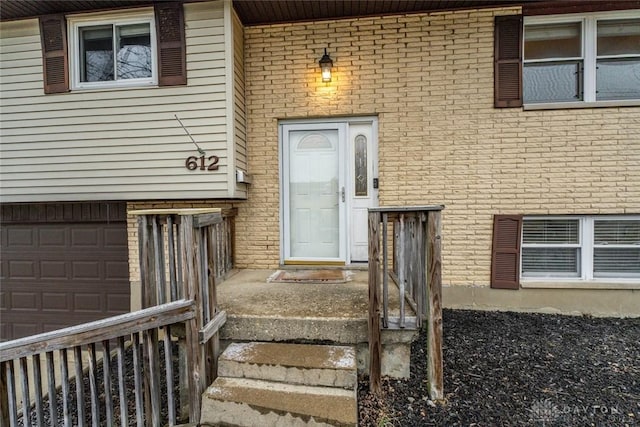 doorway to property with a garage