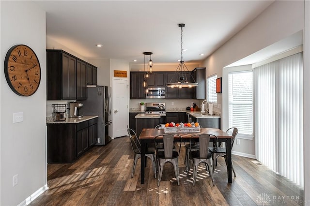 dining space with dark wood-type flooring and sink