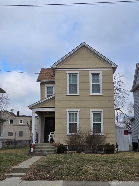 view of front of property featuring covered porch and a front lawn