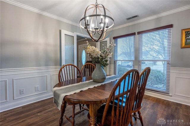 dining room featuring dark hardwood / wood-style flooring, a notable chandelier, and crown molding