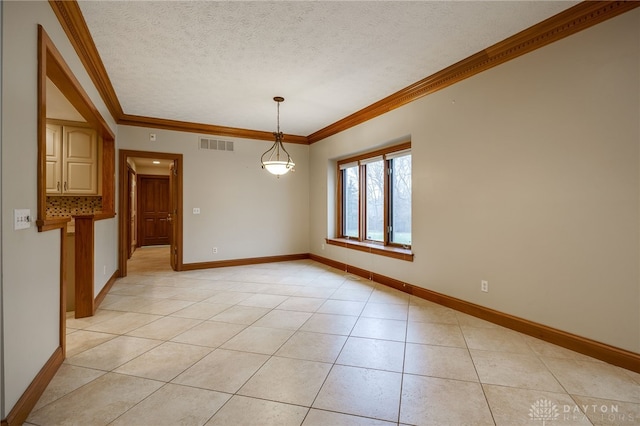 spare room with a textured ceiling, visible vents, crown molding, and light tile patterned floors