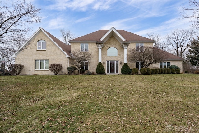 view of front of house with brick siding and a front yard