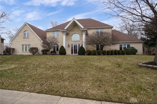 view of front of property with brick siding and a front yard
