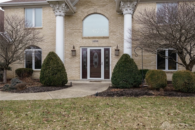 view of exterior entry with brick siding