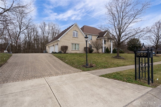 view of front of property with brick siding, driveway, an attached garage, and a front lawn