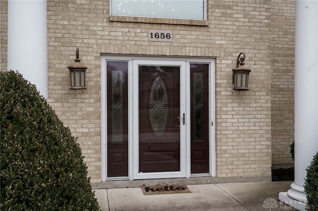 property entrance with brick siding