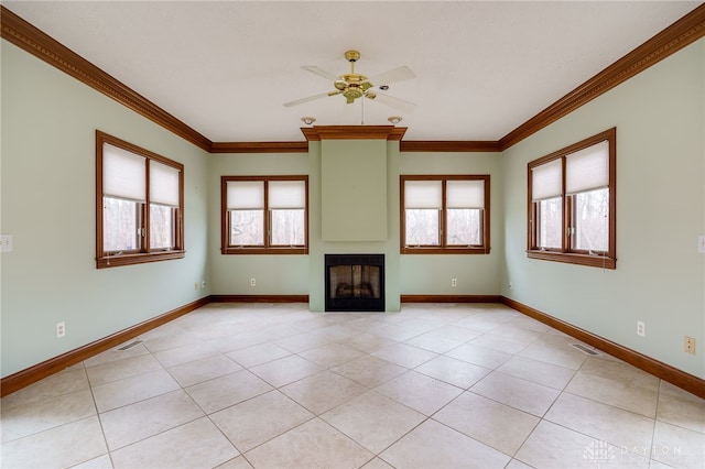 unfurnished living room with a wealth of natural light, visible vents, crown molding, and ceiling fan