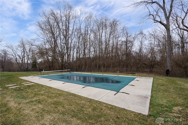 view of swimming pool featuring a fenced in pool, fence, a yard, and a patio area