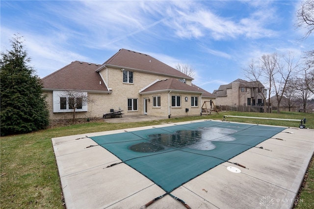 view of swimming pool with a lawn, a fenced in pool, a patio, and fence