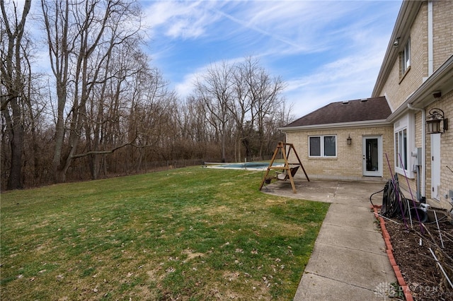 view of yard featuring a covered pool and a patio area