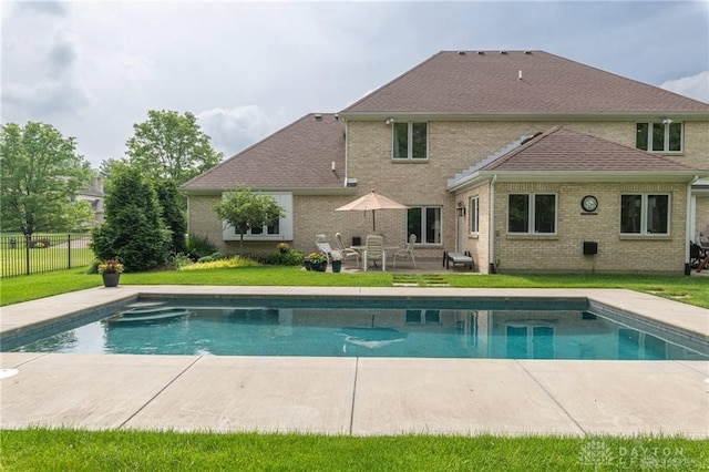 view of swimming pool with a fenced in pool, a lawn, fence, and a patio
