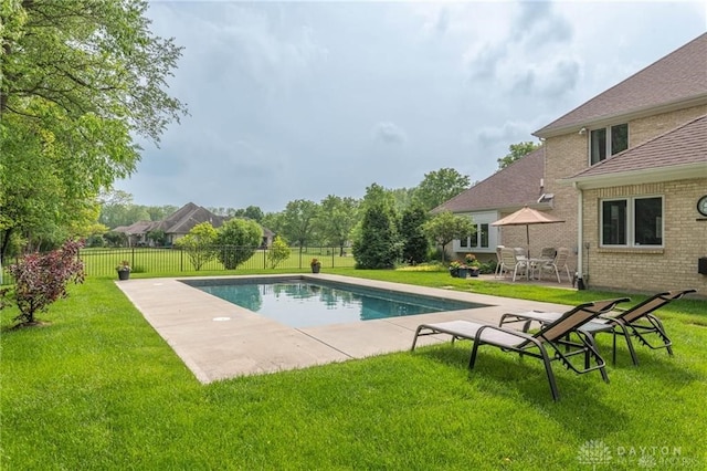 view of pool with fence, a fenced in pool, a yard, and a patio area