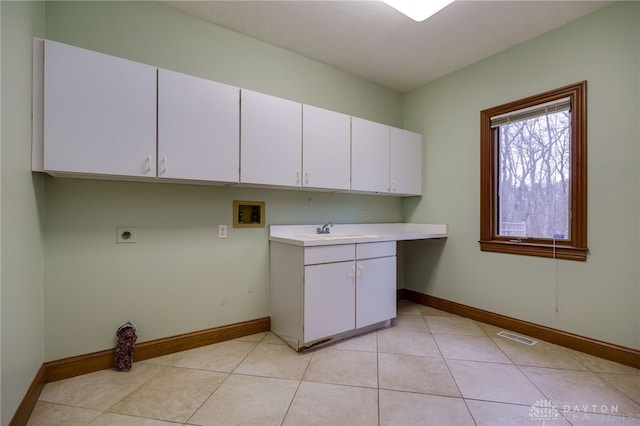 washroom featuring hookup for a washing machine, a sink, visible vents, cabinet space, and electric dryer hookup