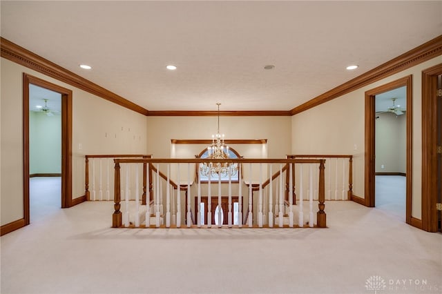 corridor with an upstairs landing, carpet flooring, and a chandelier
