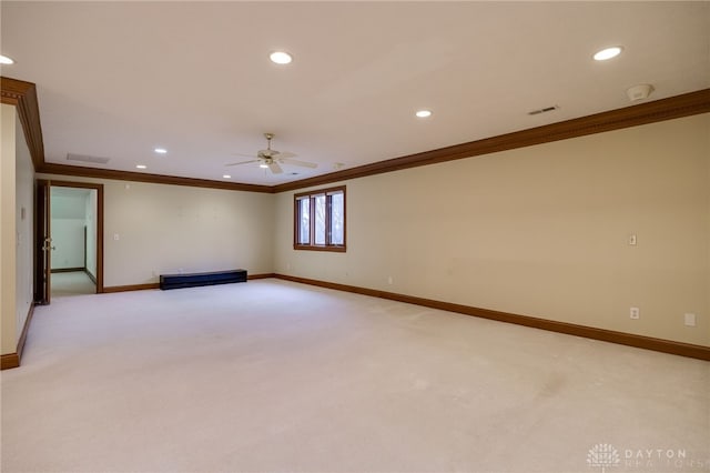 empty room featuring light colored carpet, baseboards, ornamental molding, and a ceiling fan