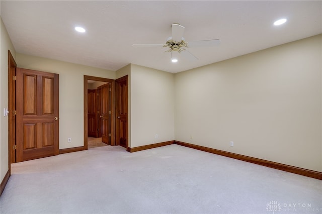 unfurnished bedroom featuring light carpet, baseboards, ensuite bath, and recessed lighting