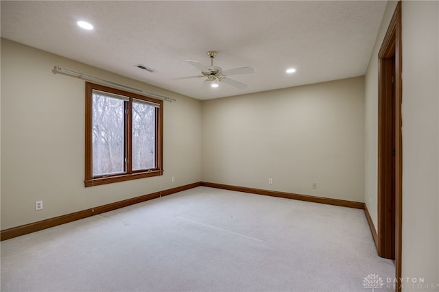 empty room with light colored carpet, recessed lighting, baseboards, ceiling fan, and visible vents
