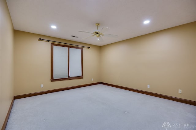carpeted empty room with baseboards, ceiling fan, visible vents, and recessed lighting