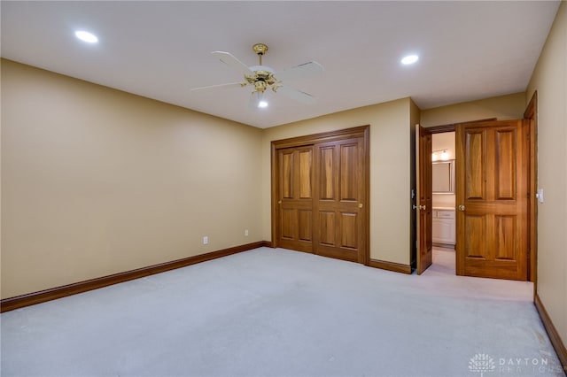 unfurnished bedroom featuring light carpet, baseboards, and recessed lighting