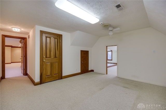 bonus room featuring light carpet, lofted ceiling, and visible vents