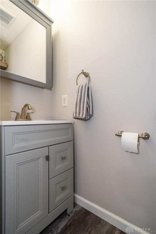 bathroom with vanity and hardwood / wood-style floors