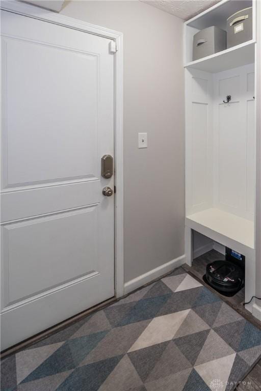 mudroom with a textured ceiling