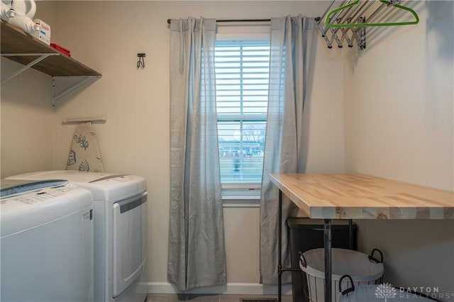 washroom with a healthy amount of sunlight and separate washer and dryer