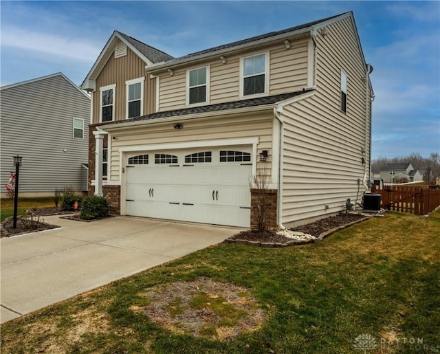 view of front of home with a garage, central AC, and a front yard