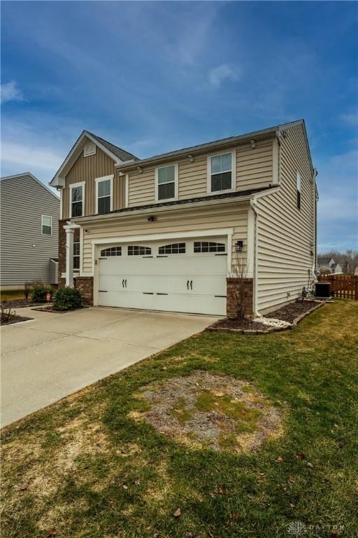 view of front of house featuring a garage, central AC, and a front yard