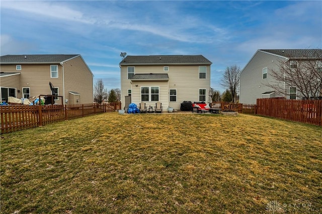 back of house with a patio area and a lawn