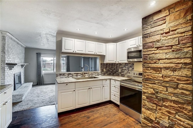 kitchen with white cabinetry, stainless steel appliances, and sink