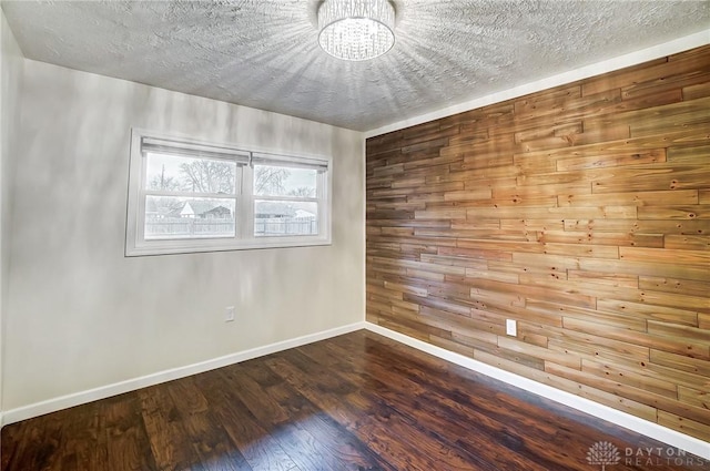 empty room featuring hardwood / wood-style floors and a textured ceiling