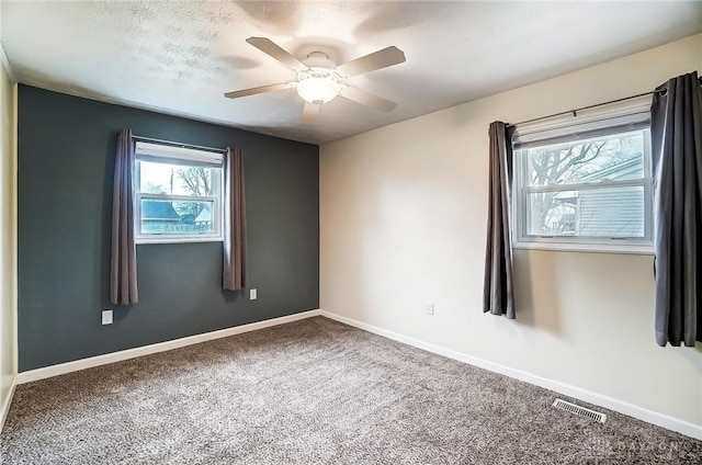 carpeted empty room featuring ceiling fan